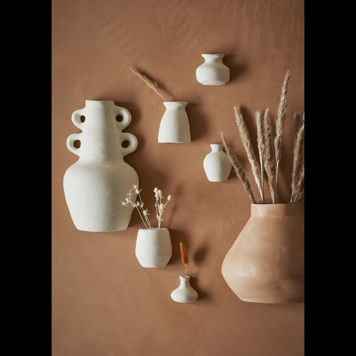 Wall-mounted paper mache vases